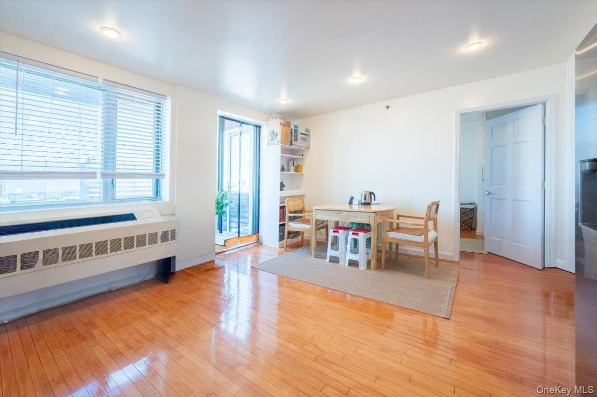Dining area featuring light wood-type flooring and radiator