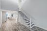 Dining Room Area & Stairs leading to upstairs Bedroom, Den and Full Bath