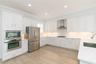 Upgraded appliances, quartz counters, wood cabinetry...