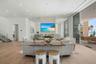 The open floor plan is surrounded by 11 and 10 foot Floor-to-ceiling Premium ES Insulated Sliders with sweeping Gulf views