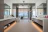 Primary bathroom has dula sinks, a dedicated vanity/ makeup area, and a wet room