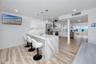 Large kitchen with two bar islands complete with waterfall quartz to the floor