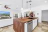 Butcher block island houses dishwasher, sink and ice maker