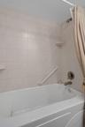 Jetted tub/shower combo in primary suite.  A small storage area is just behind.