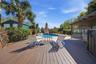 Deck with hot tub to right and view of gorgeous pool