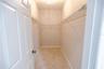 Spacious primary walk-in closet offering plenty of room for organization.