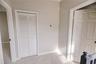 Quaint landing leading to primary bedroom