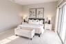 Spacious primary suite with elevated water views and private balcony.