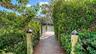 Private dock access through lush landscaping