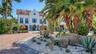 Grand arrival framed by tropical landscaping
