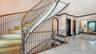 Grand curved staircase with custom ironwork
