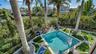 Private tropical pool overlooking canal
