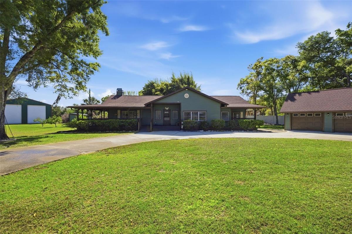 Front of house with Double RV garage in the back and 3 car garage to the right