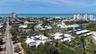 Aerial view of Whispering Sands and Ocean Blvd leading west into Siesta Key Village.