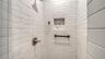 Guest bathroom tiled shower.