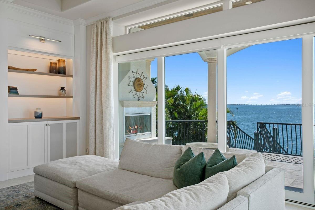 An inviting outdoor fireplace is perfectly positioned on the balcony just beyond the family room.