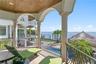 Private balcony off the main level primary suite, overlooking sparkling waters.