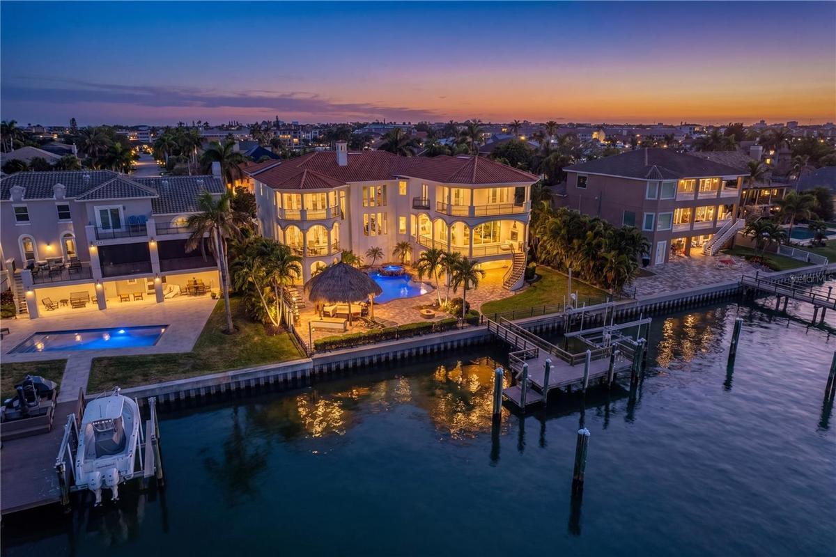 Stunning twilight view of the rear elevation of this exceptional Tierra Verde residence.