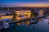 Stunning twilight view of the rear elevation of this exceptional Tierra Verde residence.