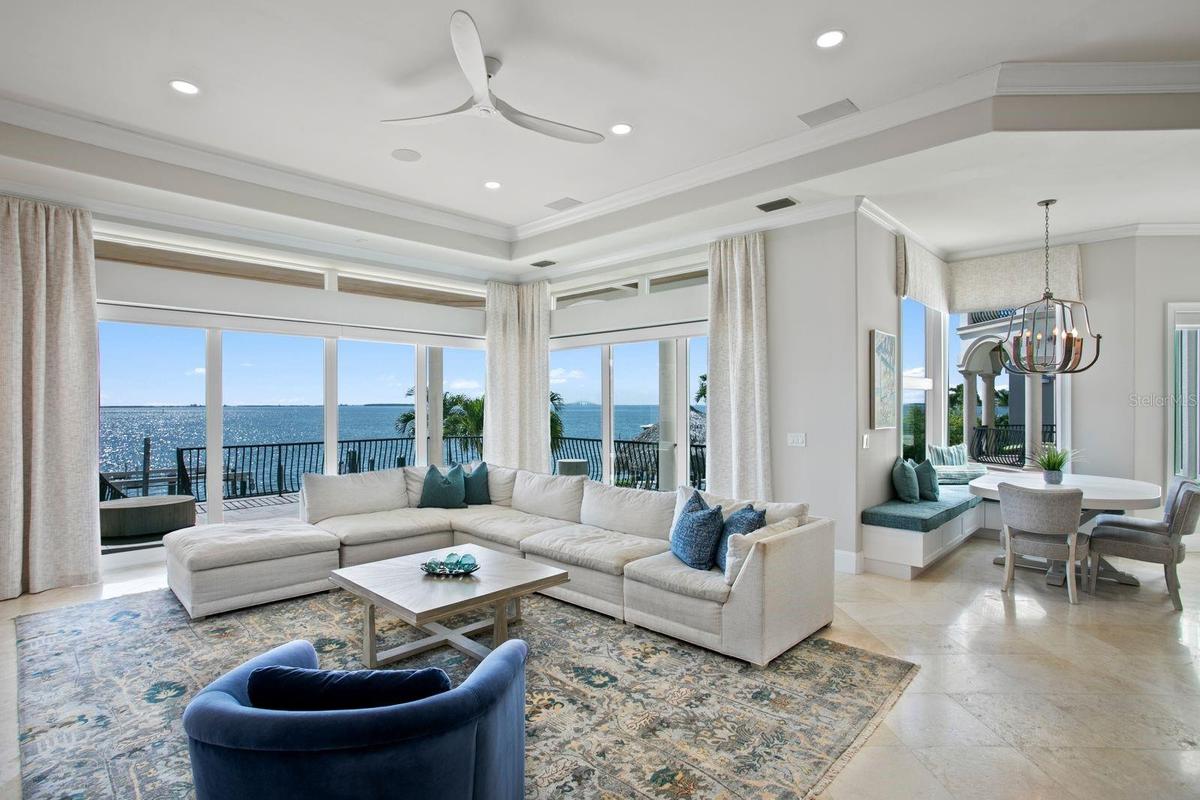 The family room and breakfast area are perfectly positioned to capture sweeping wide-open water views.