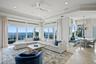 The family room and breakfast area are perfectly positioned to capture sweeping wide-open water views.