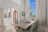 Elegant dining room just off the entry, framed by double glass doors.