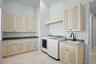 Spacious laundry with linen closets and a dedicated workspace.