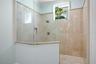 View of the walk-in shower in the main level primary ensuite.