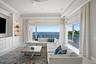 Another stunning perspective of the family room showcasing the fully opened sliders and seamless indoor-outdoor living.