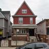 Red siding exterior with a prominent gable roofline