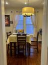 Dining area featuring wood-finish flooring, recessed lighting, and a drum pendant light fixture