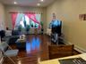 Spacious living area featuring wood-finish flooring, recessed lighting, and large windows