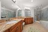 primary bath with double vanities and dressing area