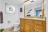 Oakwood primary bathroom With polished granite surfaces. Stainless steel steel turned handles And mirror