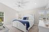 Spacious primary suite enhanced by abundant natural light