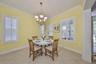 Dining room or formal living room adorned with windows.