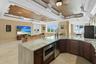 Quartzite full bar with microwave, a Scotsman specialty icemaker and large full screen TV with breathtaking sunset views and a balcony overlooking the