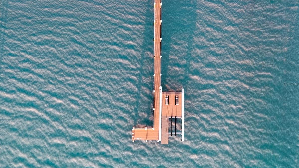 Private dock with lift, watercraft access, and direct Gulf entry.