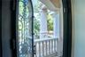 Arched black iron doors open to a private lanai off the spa-inspired marble bath with sauna, soaking tub, and custom detailing.