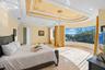 Bedroom 2 on the third level features a curved floor-to-ceiling window with endless views of the gr