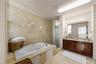 The primary bathroom feels like its own private spa, featuring a spacious layout, a beautiful jacuzzi, and the kind of atmosphere made for slowing dow