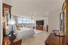 The primary bedroom is incredibly spacious and filled with natural light, with stunning views that create a peaceful and luxurious atmosphere from the