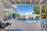 Heated pool and spa with dolphin inlay and fountain hot tub overlooking the bay