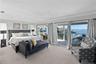 Primary suite Bedroom 2 retreat with private waterfront balcony- King Size bed. Sliding doors to covered balcony.