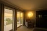 Charming porthole window adds a touch of Key West flair. Sunrise over the water in Primary Bedroom. Sliders to covered patio