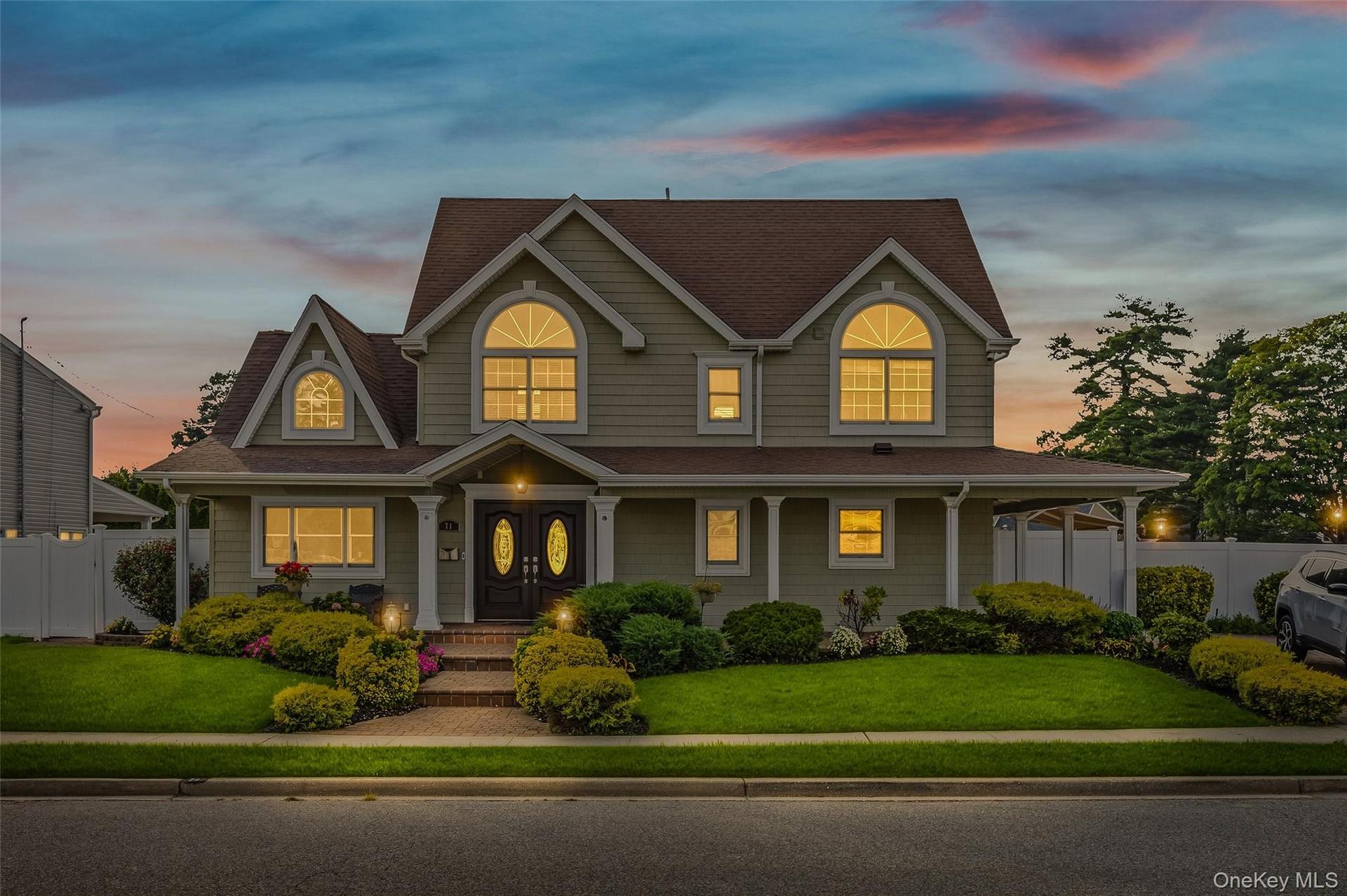 View of front facade featuring covered porch and a shingled roof