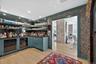 Conveniently located bar with wine fridge, dishwasher and ice machine.