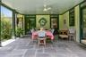 Covered terrace with dining area overlooking the gardens