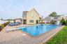 View of swimming pool with a patio, a fenced backyard, an outbuilding, and a diving board