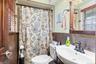 Full bath with healthy amount of natural light, vanity, and a shower with shower curtain
